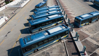 Electric buses charging on a parking lot