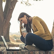 woman-laptop-headphone-coffe-cup