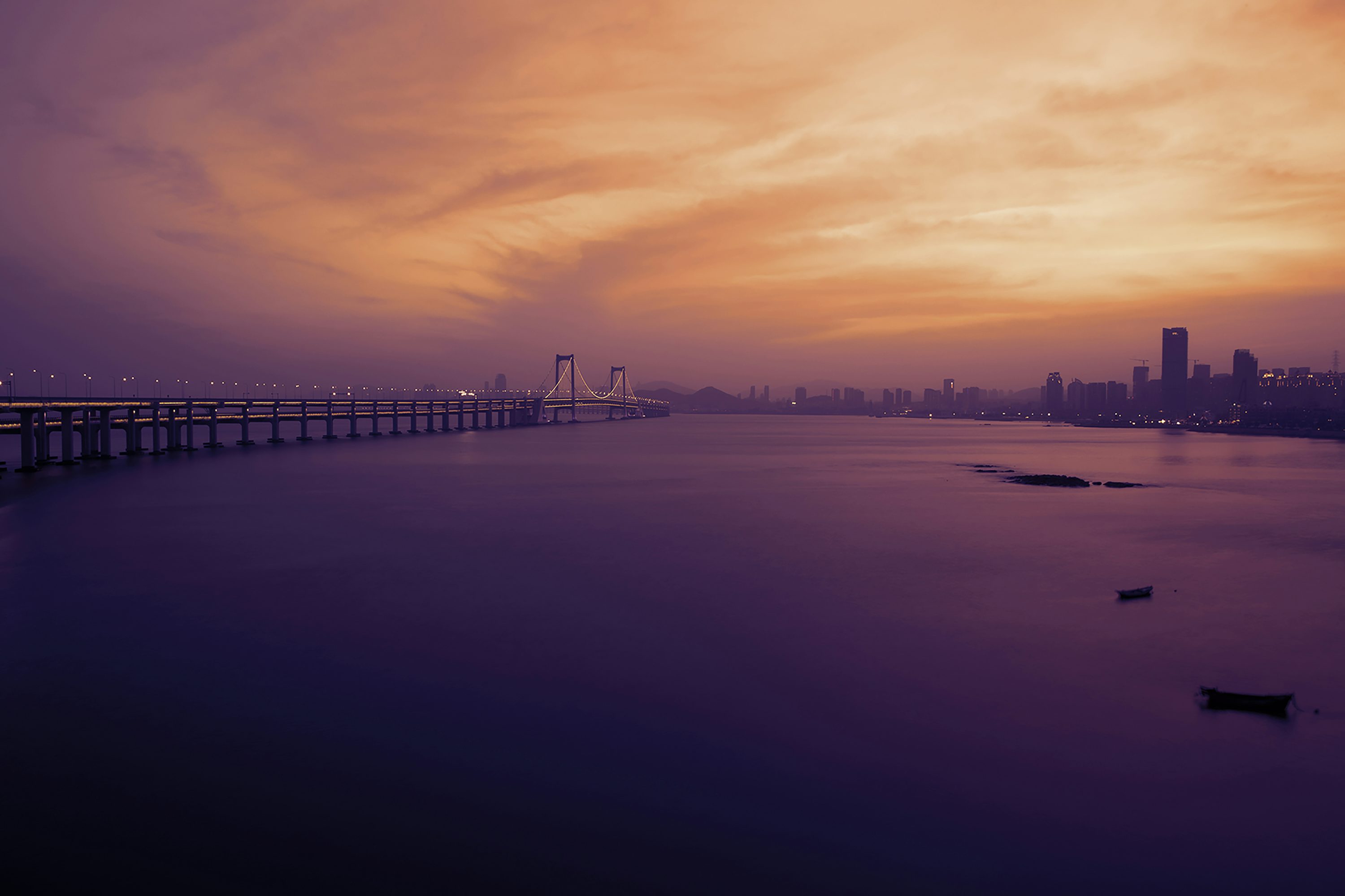 gray bridge above body of water during golden hour photography