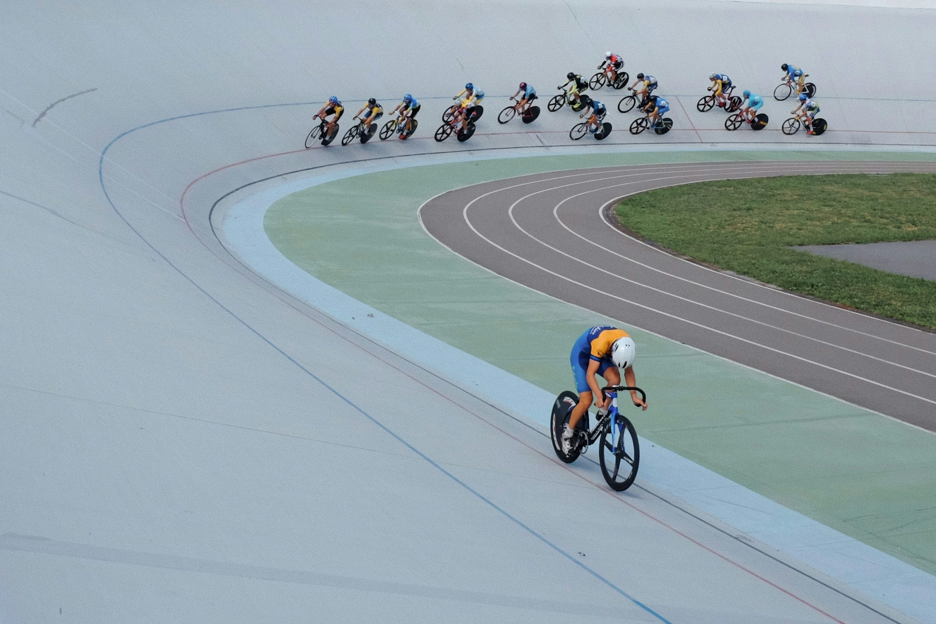 A group of people riding bikes on a track