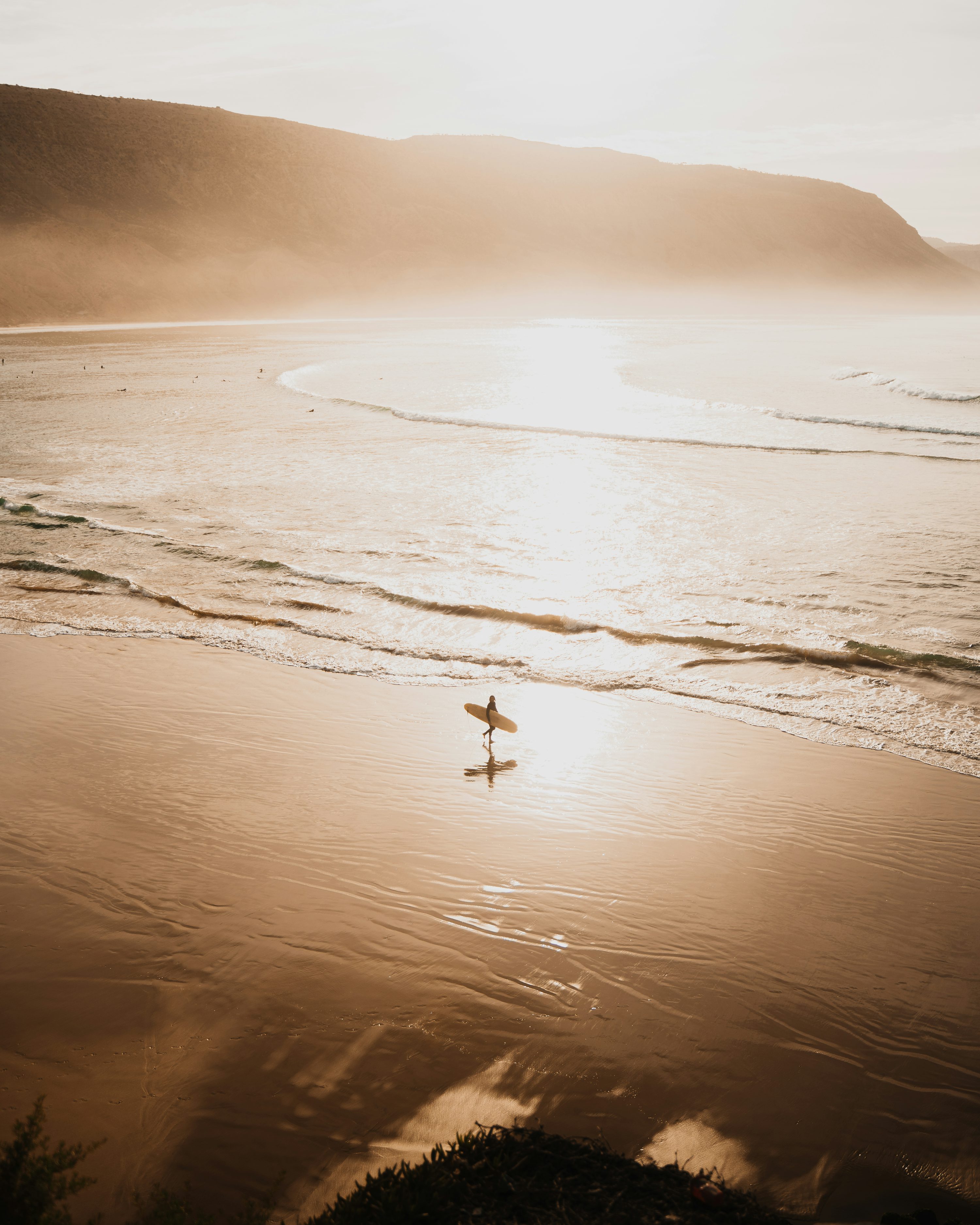 A person riding a surf board on a beach