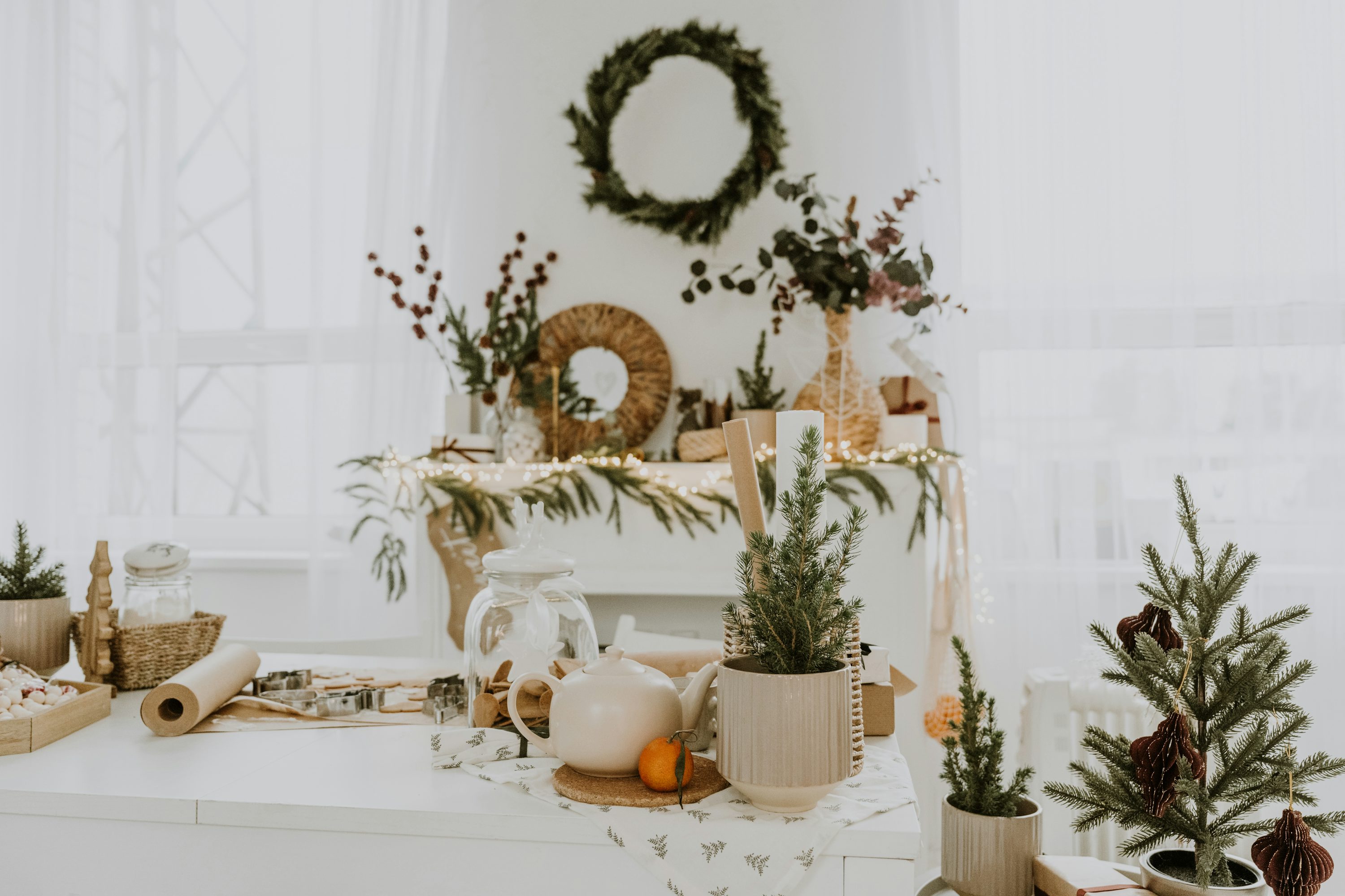 A white table topped with lots of christmas decorations