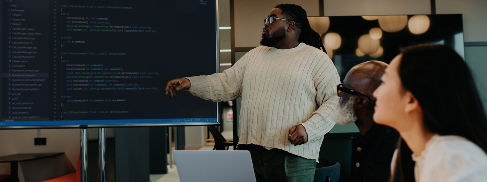 Man giving a presentation to co-workers in a business meeting.