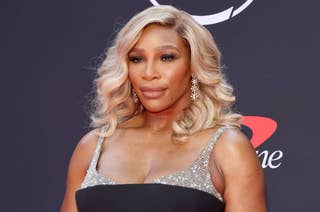 Serena Williams on the red carpet, wearing a sparkling gown with a bejeweled top and elegant waves in her hair