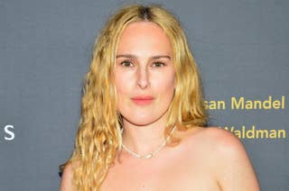 Rumer Willis poses on the red carpet in a strapless outfit, accessorized with a pearl necklace