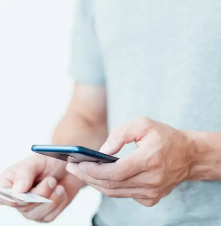 Image of a man linking his credit card to his cellphone