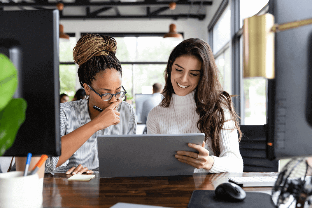 Image of two women working collaboratively at a table