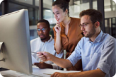 Agency professionals gathered around a laptop