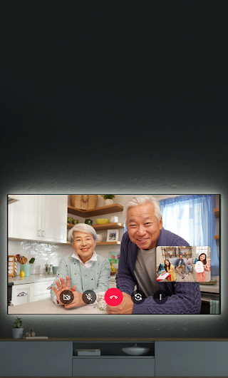 A TV in a living room showing a video call. A phone is in front of the TV showing the video call.