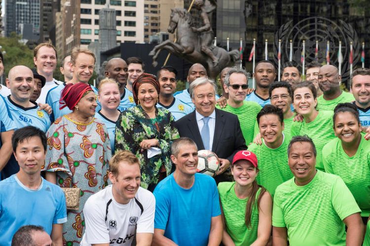 Secretary-General António Guterres (centre), Deputy Secretary-General Amina Mohammed (centre left), and Bibi Sherifa Khan, President of the United Nations Staff Union, pose with staff members taking part in a football match held as part of the celebration of UN Staff Day in New York.