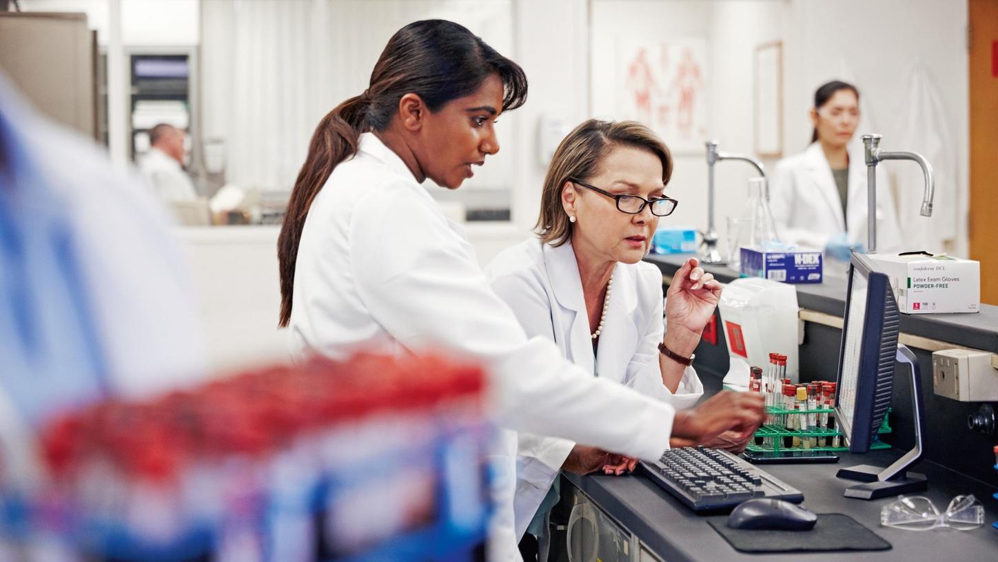 Two women working in a lab environment. 