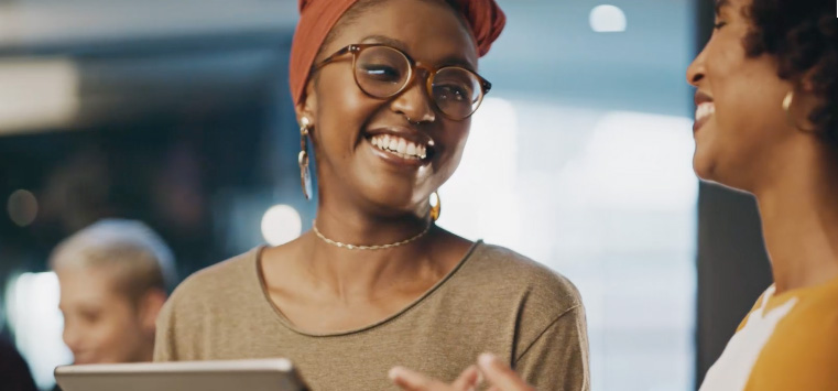 Image of two women talking in an office