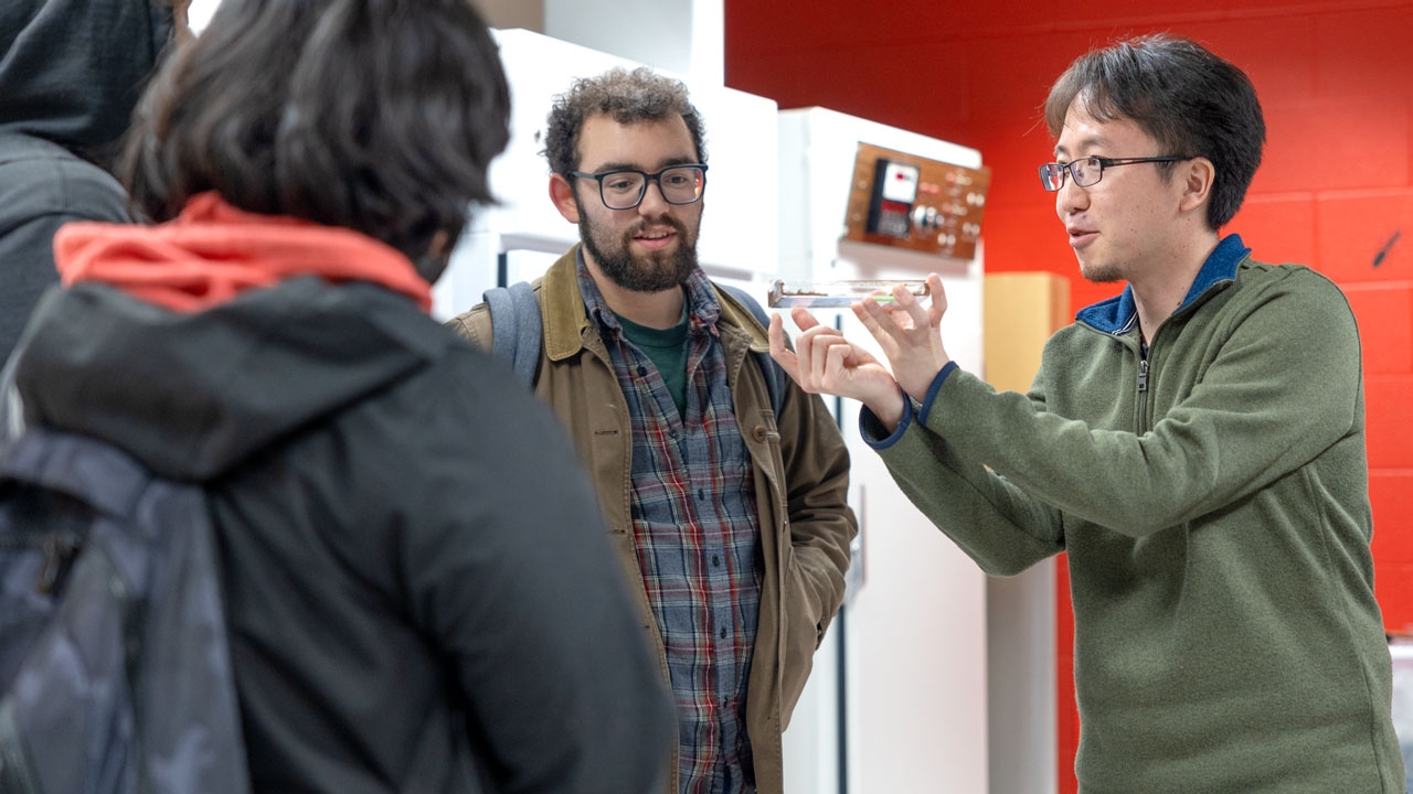 Cannon Cline accompanies prospective Indigenous high school students on a lab tour.