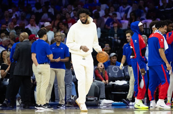 Philadelphia 76ers center Joel Embiid, in white, during a timeout at a home game in Pennsylvania on Oct. 23, 2024. Following a Nov. 2 game, Embiid shoved Philadelphia Inquirer columnist Marcus Hayes in a locker room altercation.