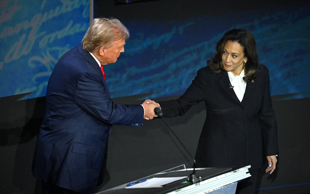 US Vice President and Democratic presidential candidate Kamala Harris (R) shakes hands with former US President and Republican presidential candidate Donald Trump during a presidential debate at the National Constitution Center in Philadelphia, Pennsylvania, on September 10, 2024. (Photo by SAUL LOEB / AFP)