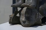 A detailed photo of an ancient South American jug shaped like a contortionist