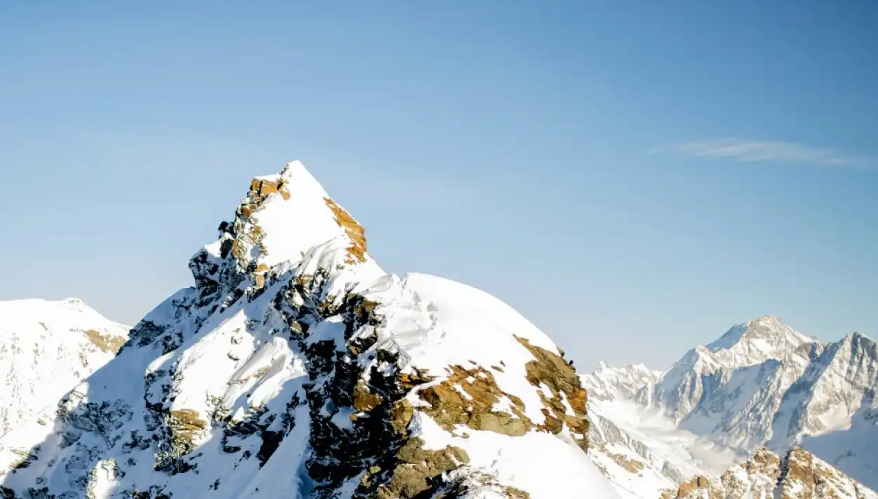 three snowy mountaintops