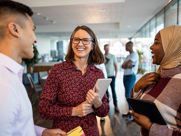 a man and two women interacting with each other in an office environment