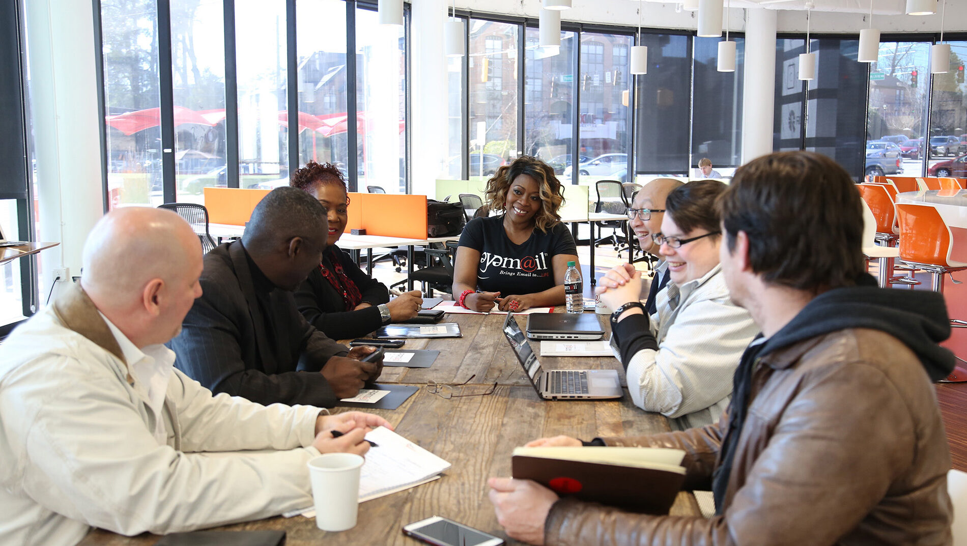 A group of people sit in an office for a team meeting