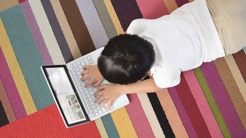 kid studying on laptop