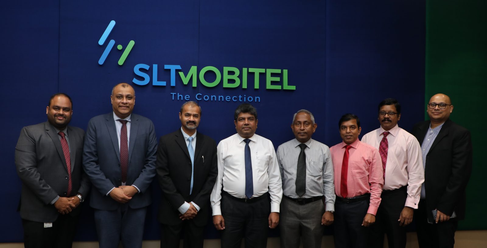 Group of men posing for a photo at an event