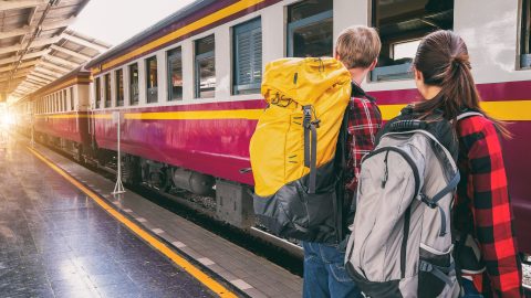 two people waiting for train