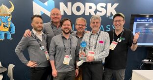 Rob Ashton, Adrian Roe, Mike English, Eric Schumacher-Rasmussen, Stan Moote, and Dom Robinson with the IABM BaM award at NAB 2024