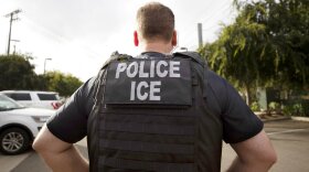 FILE - A U.S. Immigration and Customs Enforcement (ICE) officer looks on during an operation in Escondido, Calif., July 8, 2019. Data broker LexisNexis Risk Solutions allegedly violated Illinois law by collecting and combining extensive personal information and selling it to third parties including federal immigration authorities, according to a lawsuit filed Tuesday, Aug. 16, 2022, by immigration advocates. (AP Photo/Gregory Bull, File)