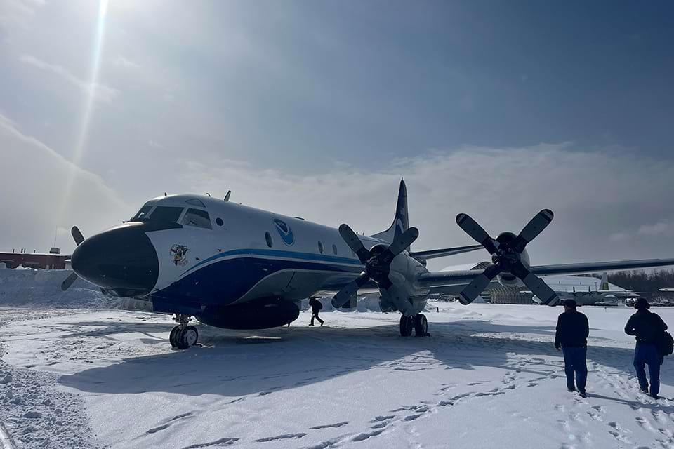 The Gravity for the Redefinition of the American Vertical Datum, or GRAV-D, crew with the plane affectionately named Miss Piggy.