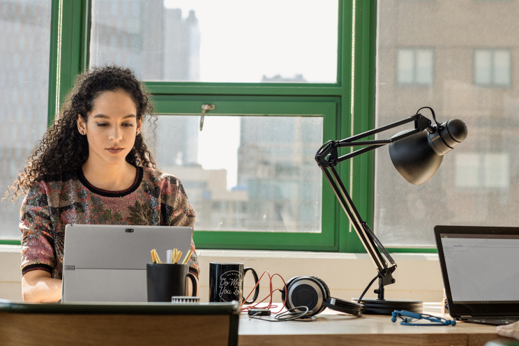 Person working on a computer at a desk