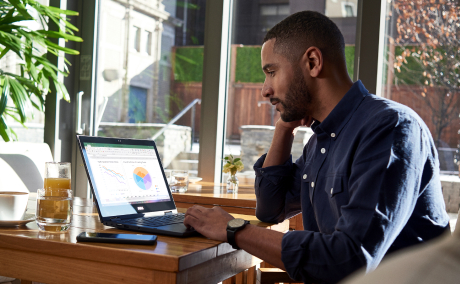 Person working on a laptop in a home office