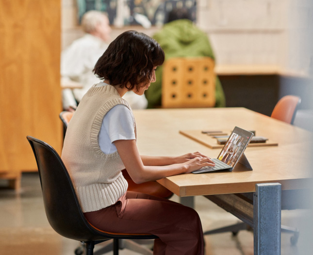 A woman having a conference call in her tablet at the office