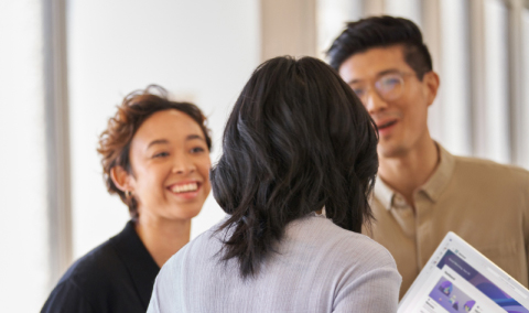 Three professionals having a happy discussion at the office