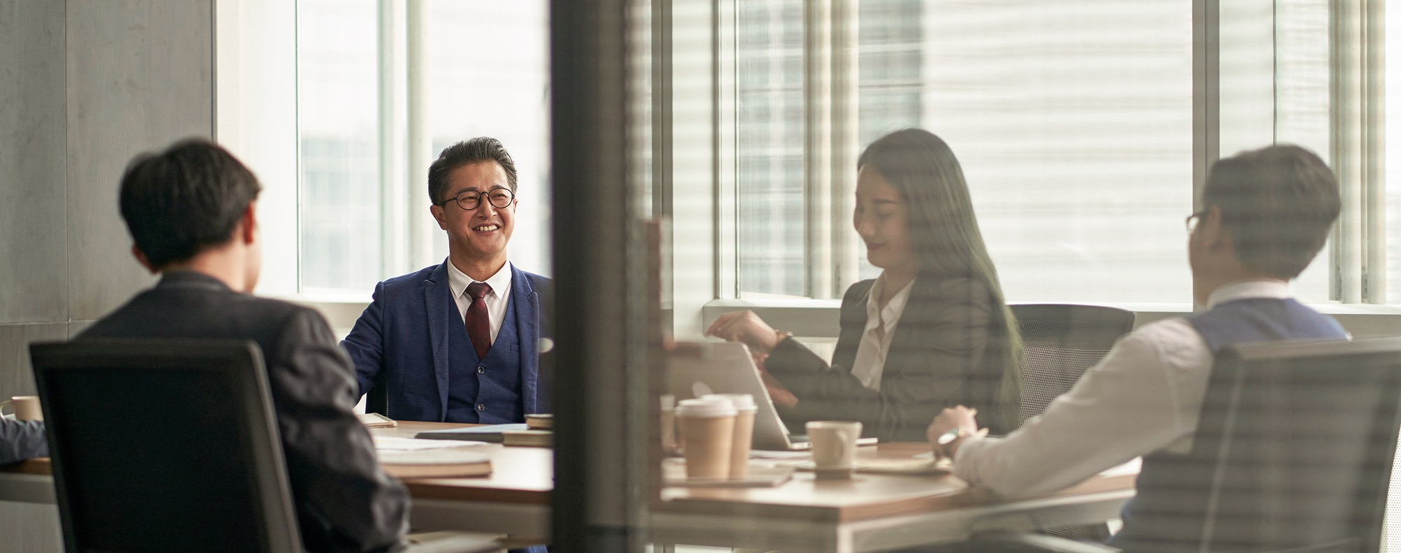 A group of businesspeople collaborating around a conference room table