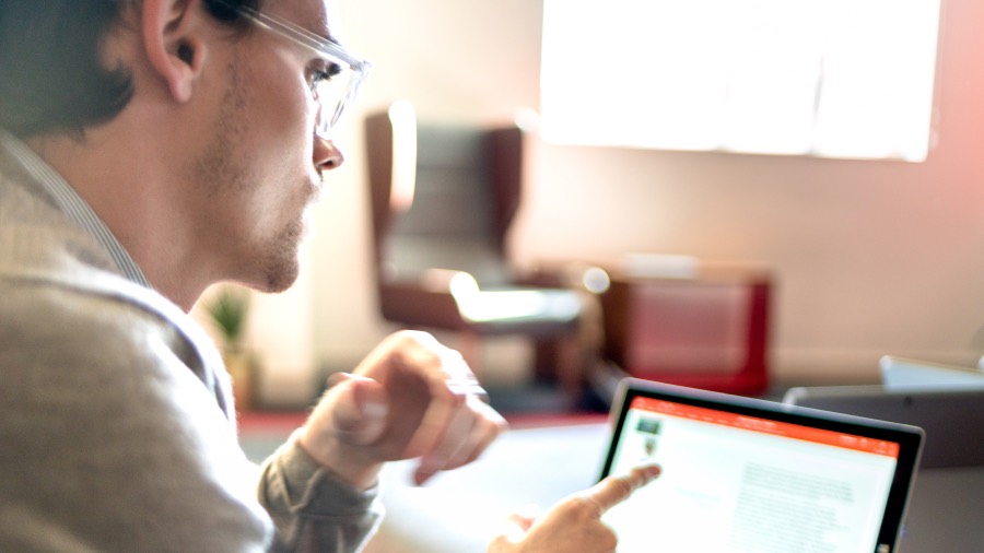 Man pointing at laptop screen