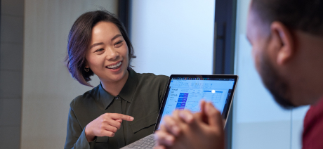 A smiling professional works on a tablet