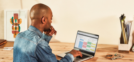 A professional schedules a meeting on a laptop