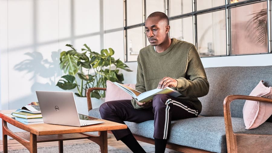 Man in green sweater on couch