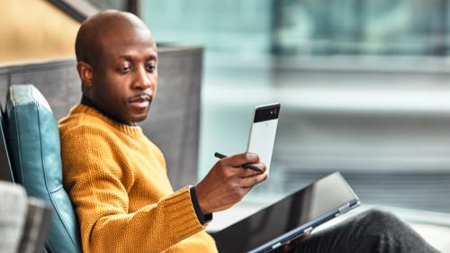 Man talking and using Surface Hub touch screen