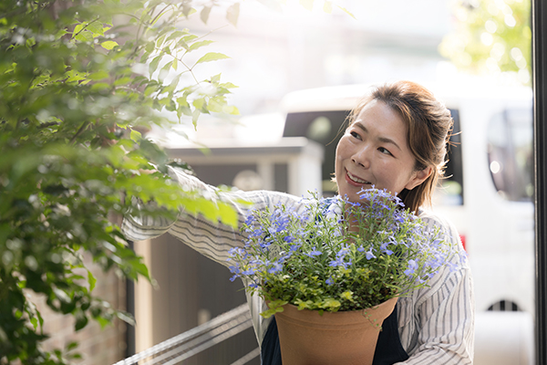 woman outside with flowers.