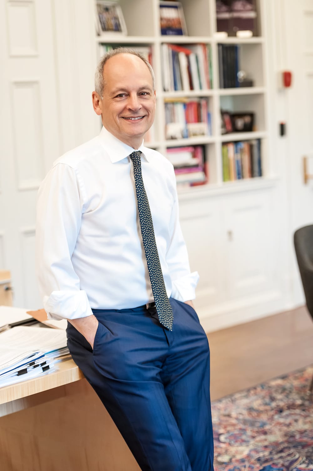 The president standing in front of a desk