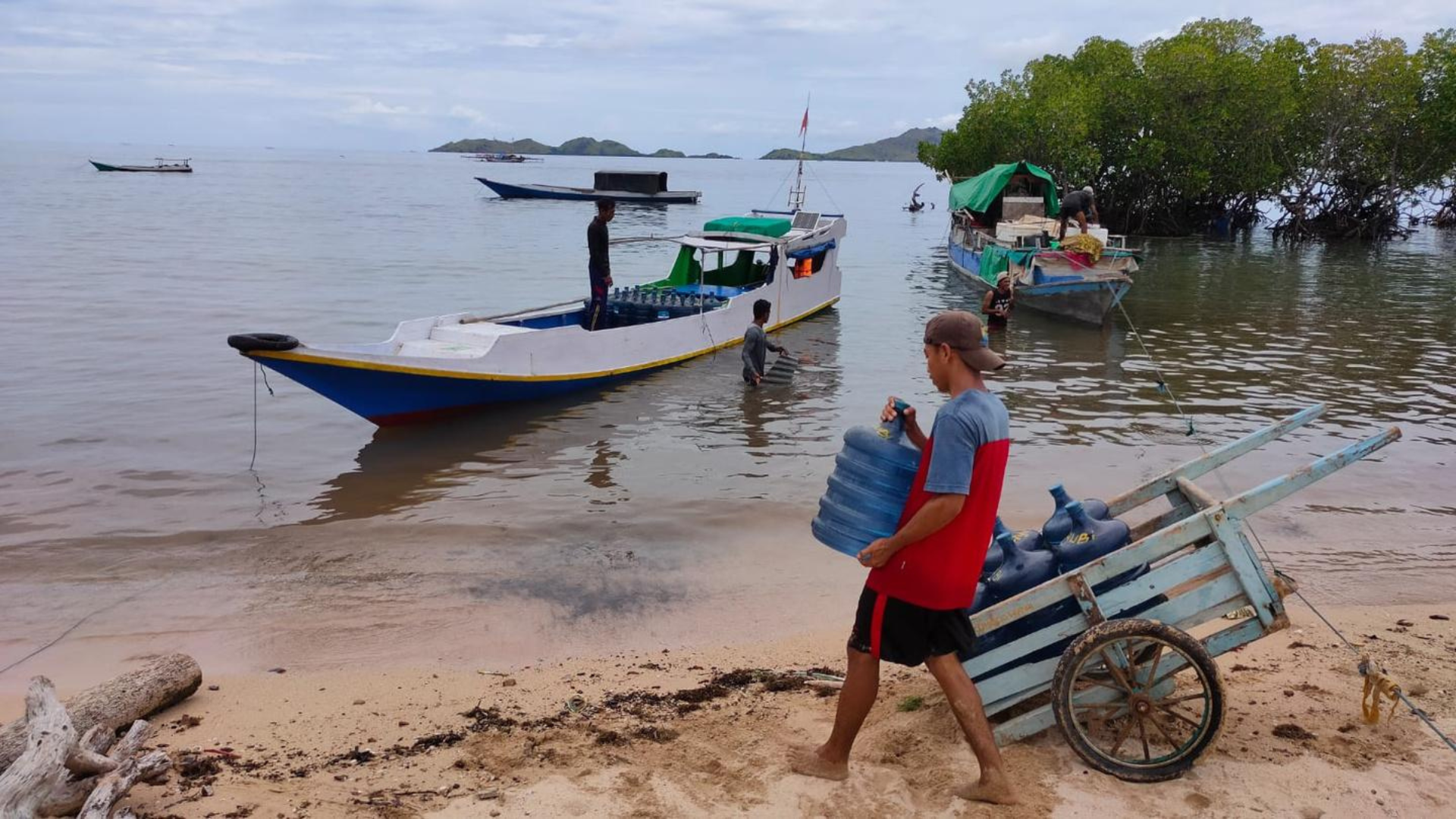 Man carries water to a boat