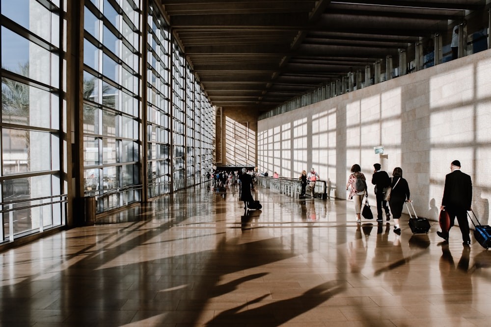 Travelers walking through an airport. 