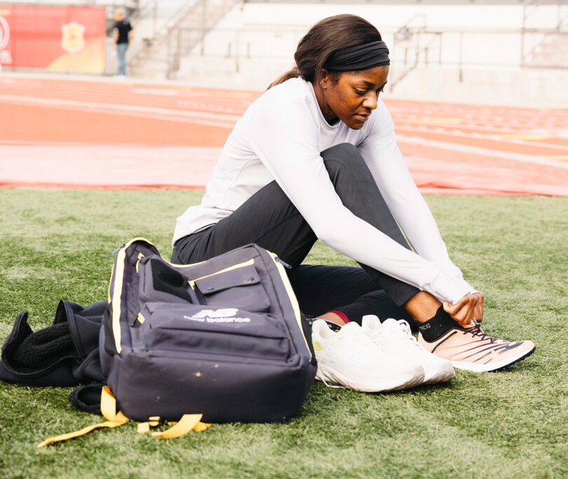 Woman ties shoes while sitting down