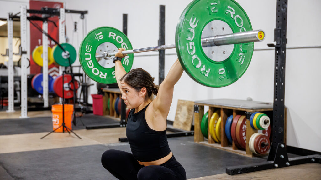 Woman lifts weights in gym