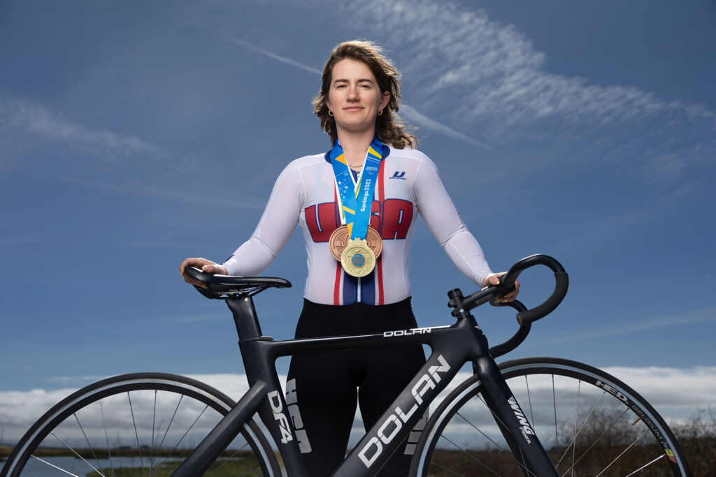 Woman stands behind a bike