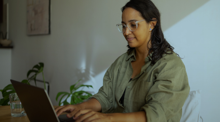 Woman sitting and using her laptop for work