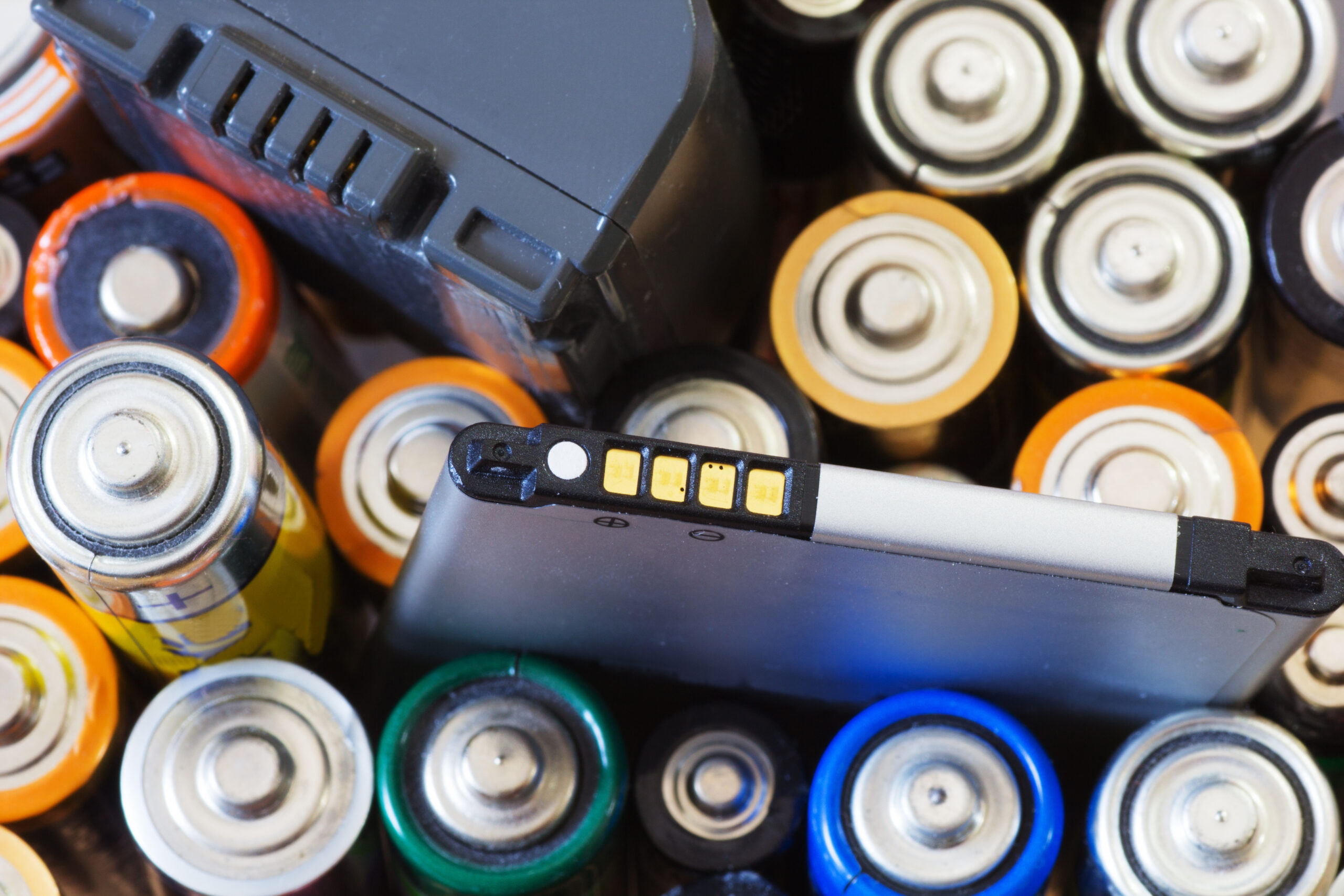 Group of old used batteries for recycling in different size. Selective focus.