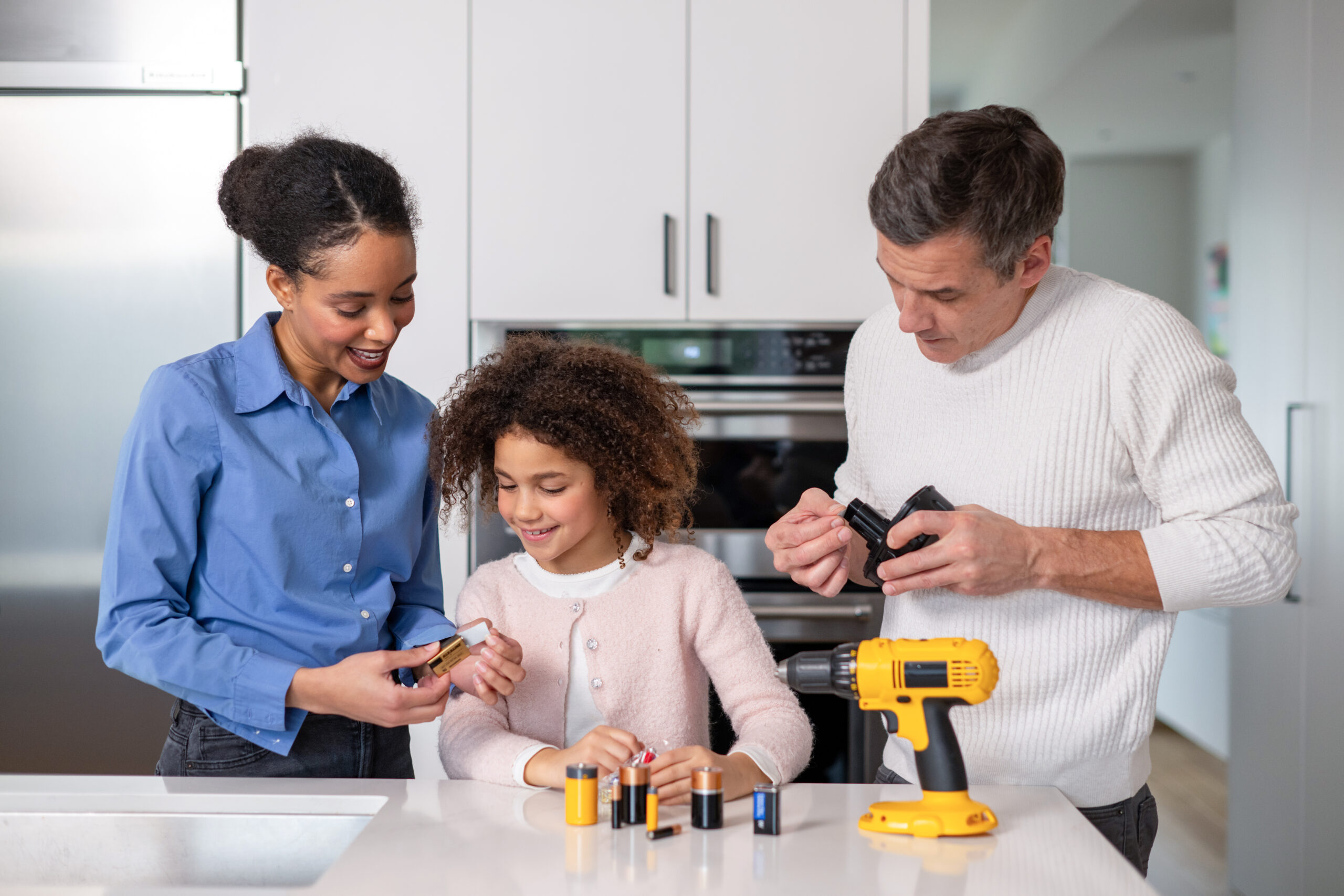 Dad, mom and daughter protecting batteries