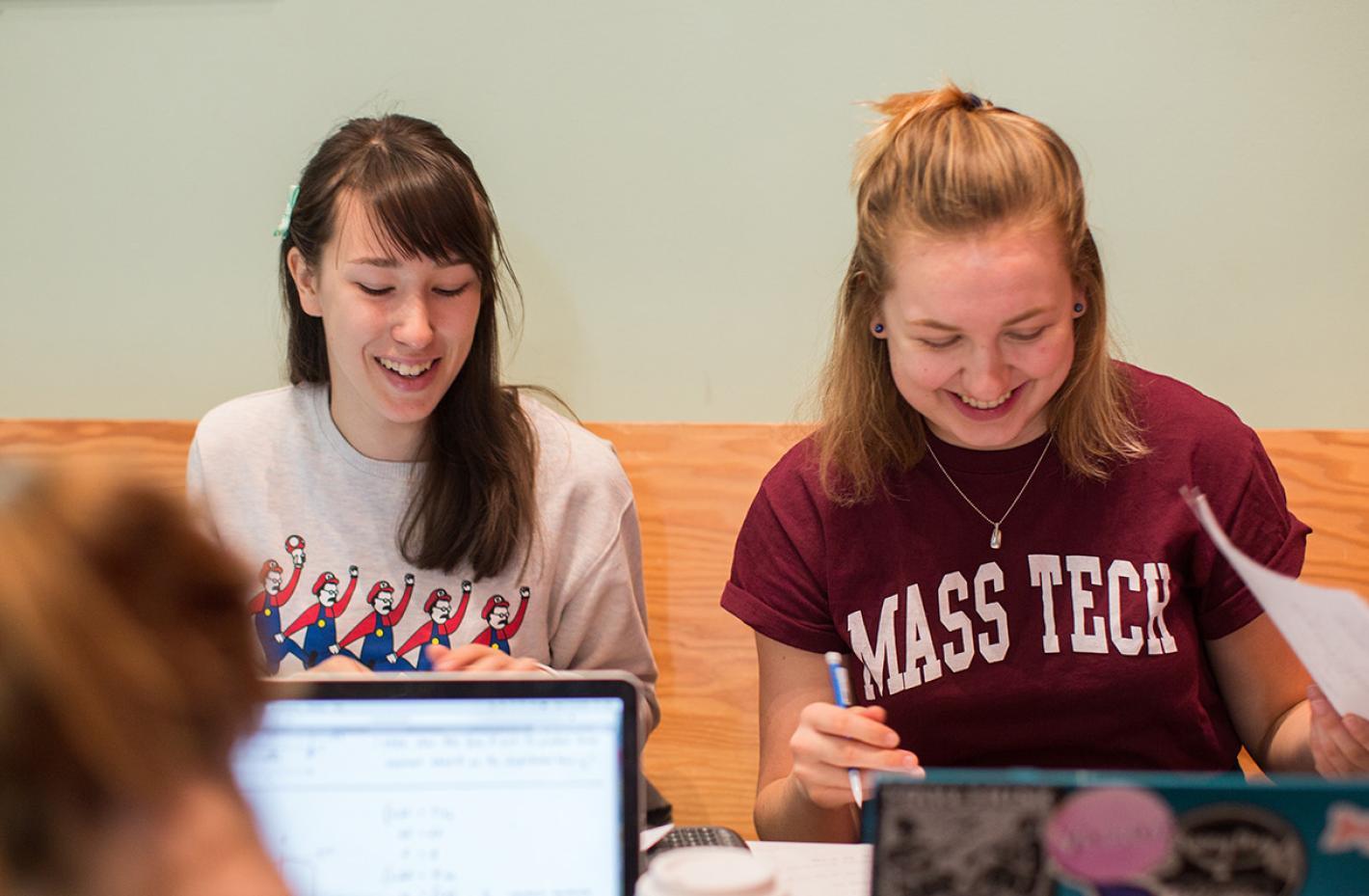 Students at table studying. 